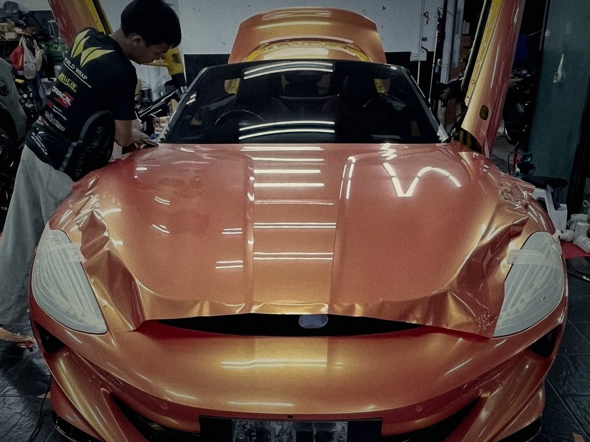 MG Cyberster receiving a copper-gold color change wrap, install in progress