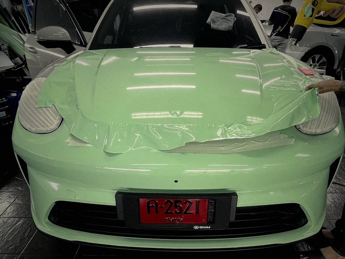 Mint green coupe receiving paint protection film application